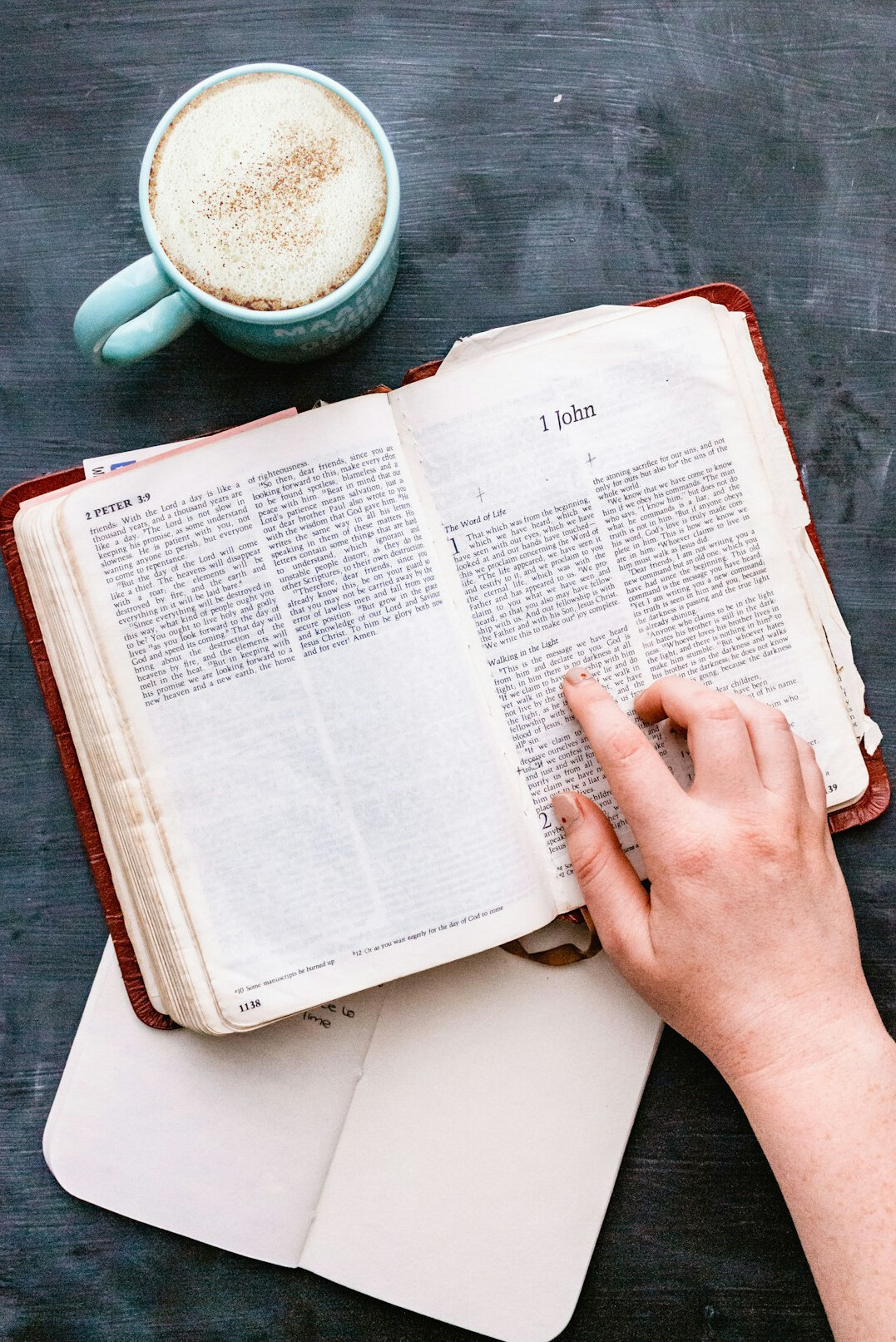 Hand writing notes in a notebook