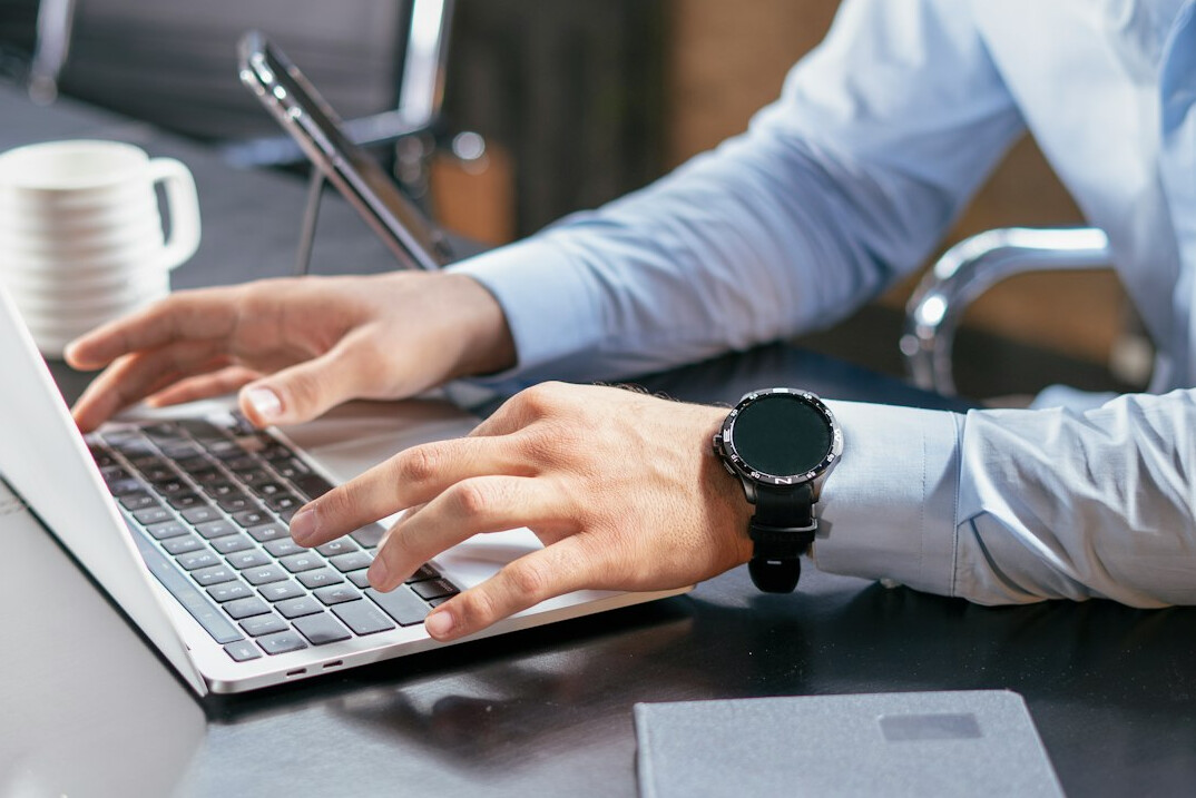 person writing email on laptop